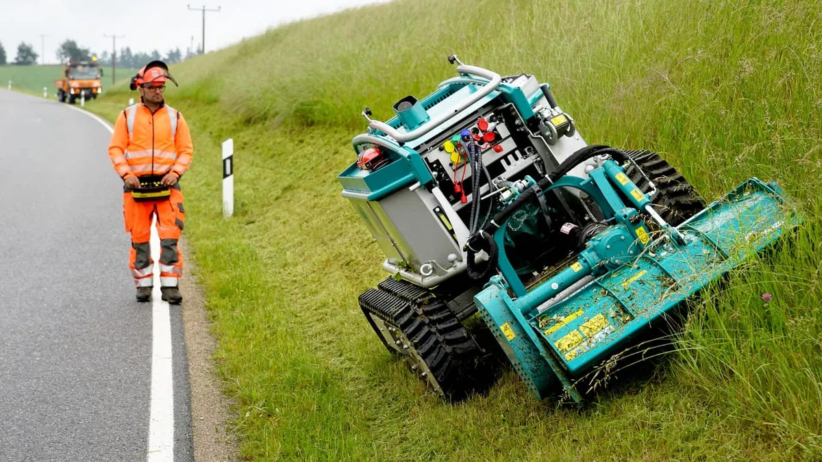 Pfanzelt Moritz mulching a road verge, the operator on the roadside with the remote