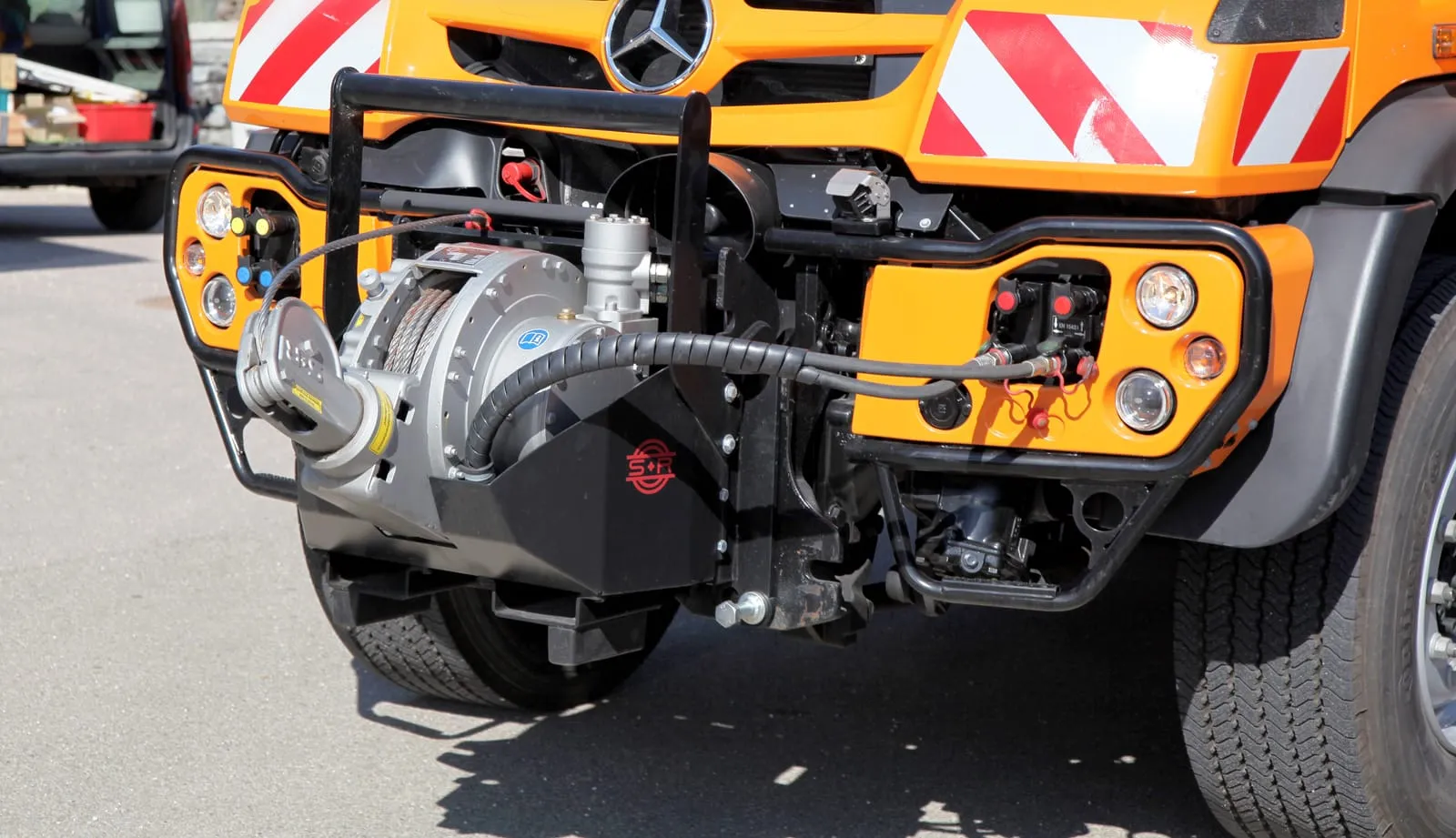 Schlang &amp; Reichart front recovery winch on an orange Mercedes-Benz Unimog