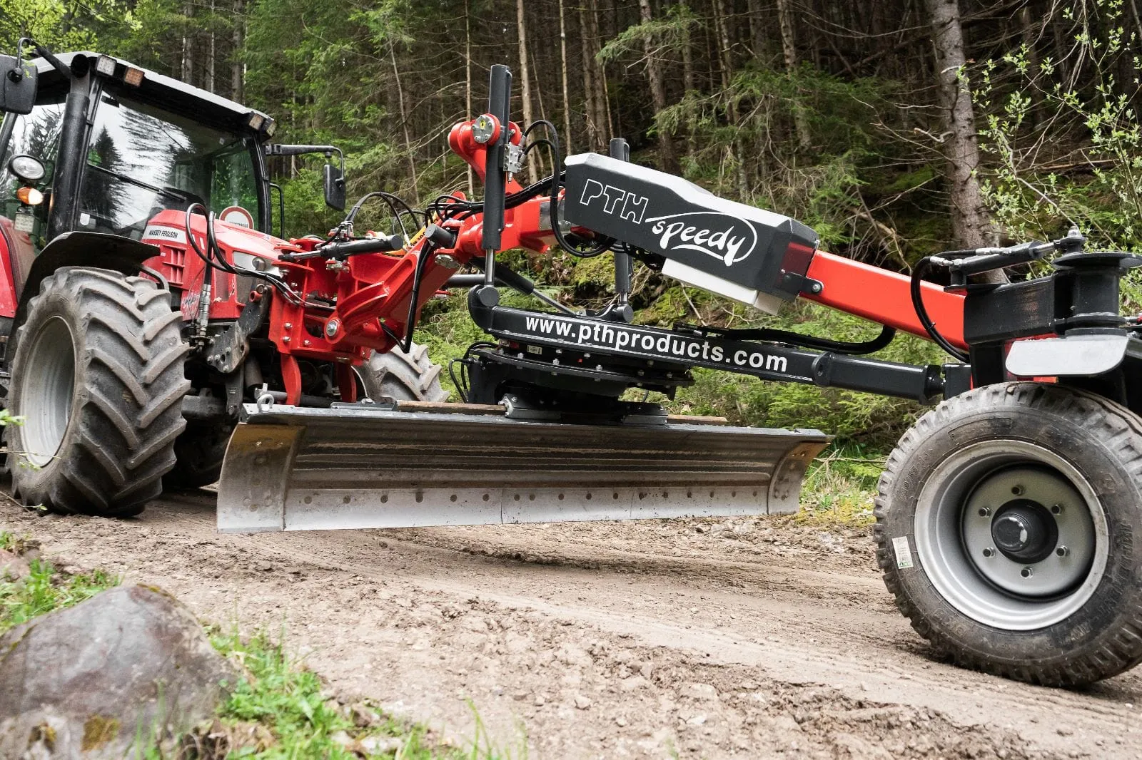 PTH Speedy front grader on a tractor at a forest road