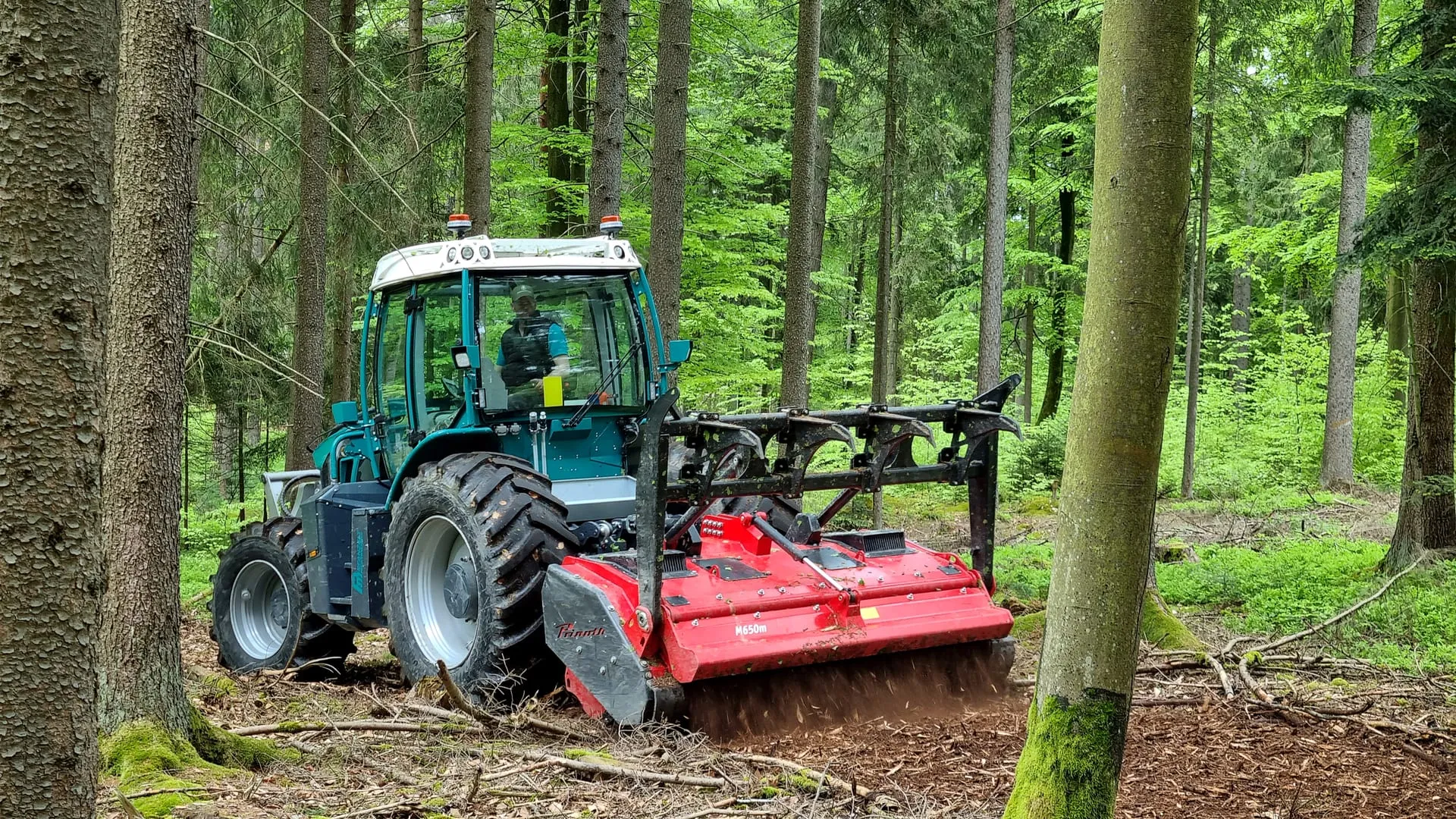 Pfanzelt Pm Trac with a forestry mulcher in a woodland clearing