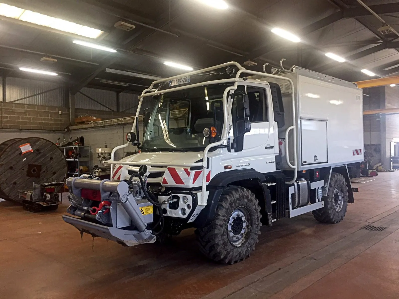 Mercedes-Benz Unimog with a Schlang &amp; Reichart front winch, in a workshop