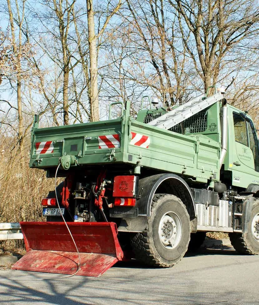 Mercedes-Benz Unimog with a Schlang &amp; Reichart winch and tipper body, seen from behind