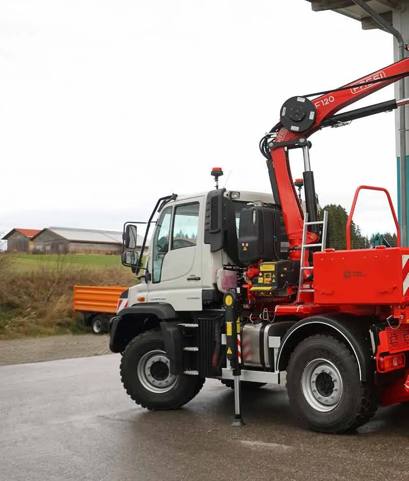 Mercedes-Benz Unimog with a Fassi loading crane and grab, mounted by Schlang &amp; Reichart